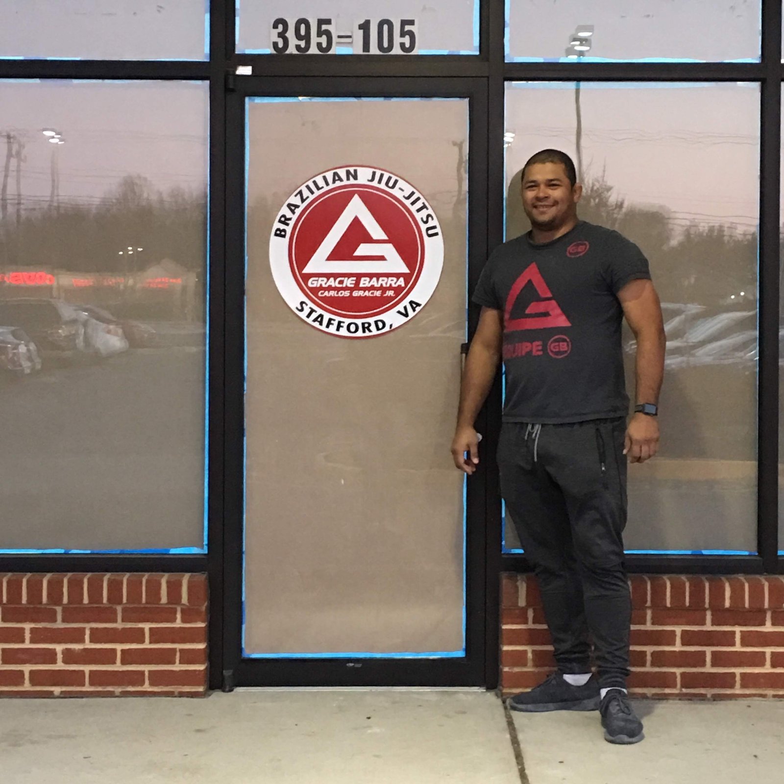 Thiago Reinaldo standing at the entrance of Gracie Barra Stafford before the academy opened